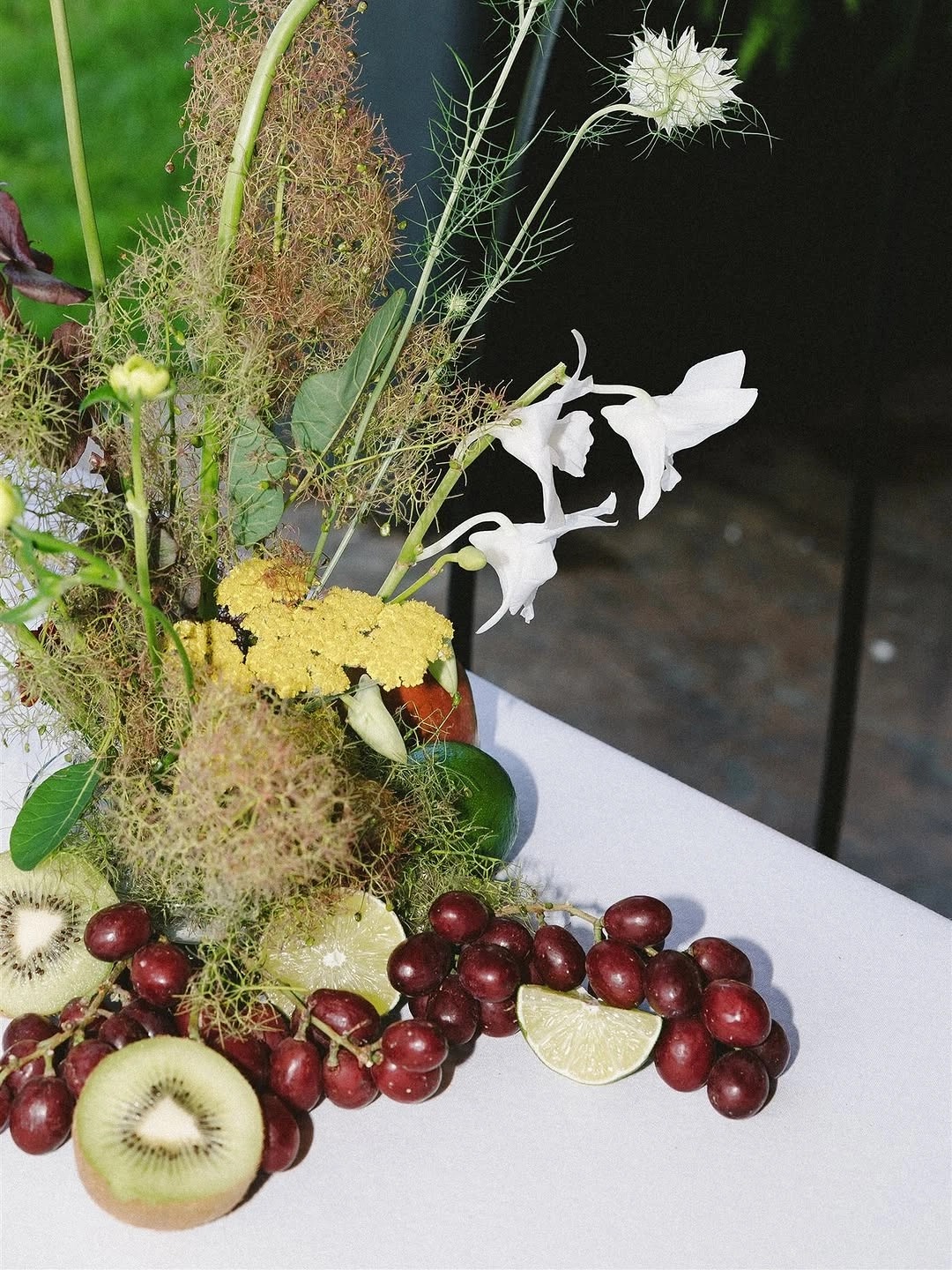 A sculptural arrangement of seasonal produce, flowers and gathered botanicals